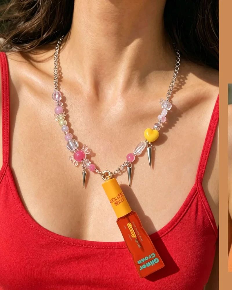 Model wearing Glossy Lip Oil as pendant necklace in Marshmallow Glow